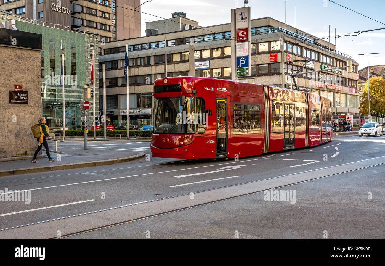 red tram that runs through the city - INNSBRUCK Austria, Europe. urban scene Stock Photo