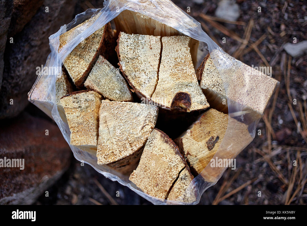 Supply of chopped dry fire wood in a plastic bag for a camping trip