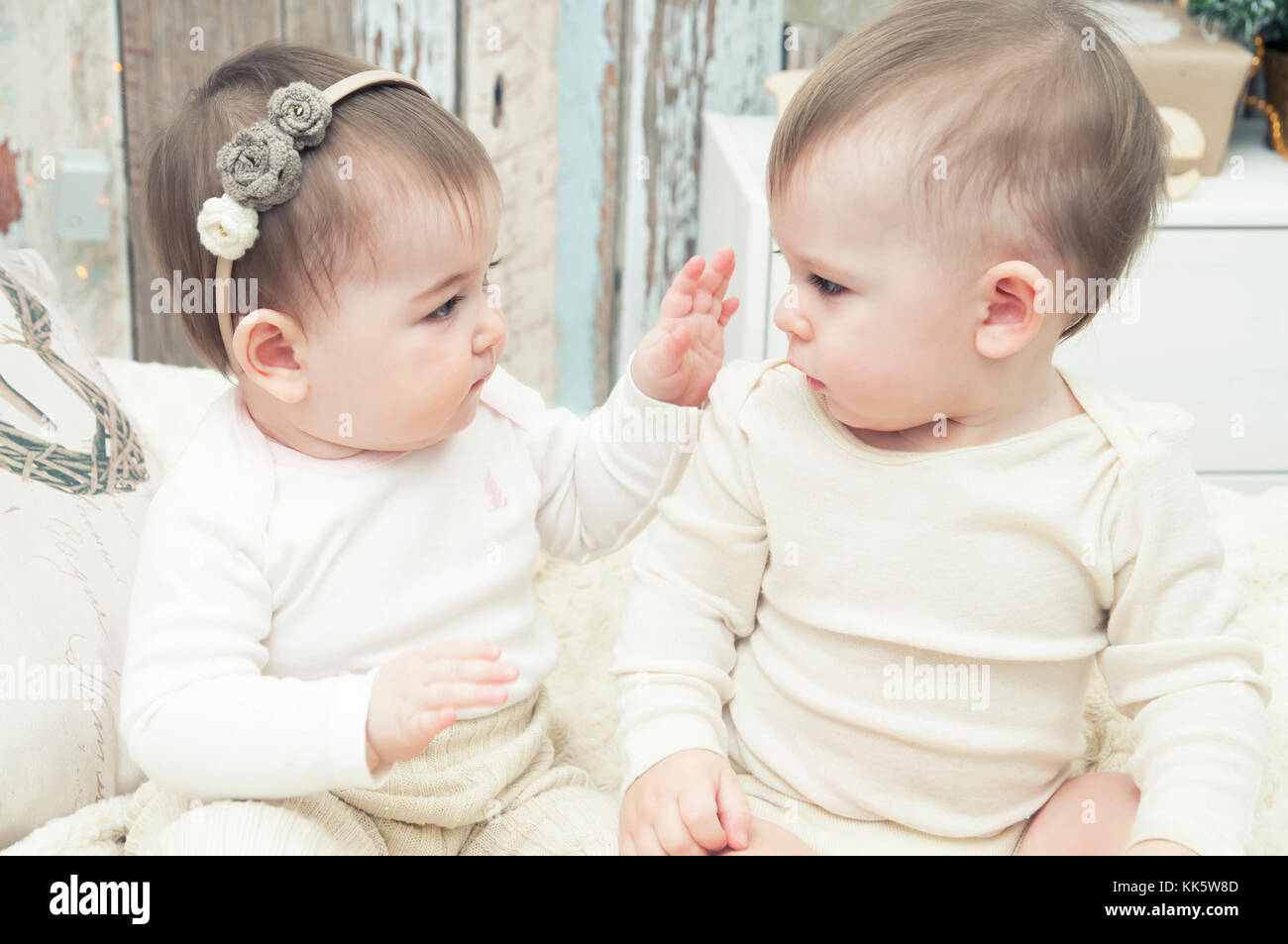 Two small children, a boy and a girl in natural cloth diapers, natural