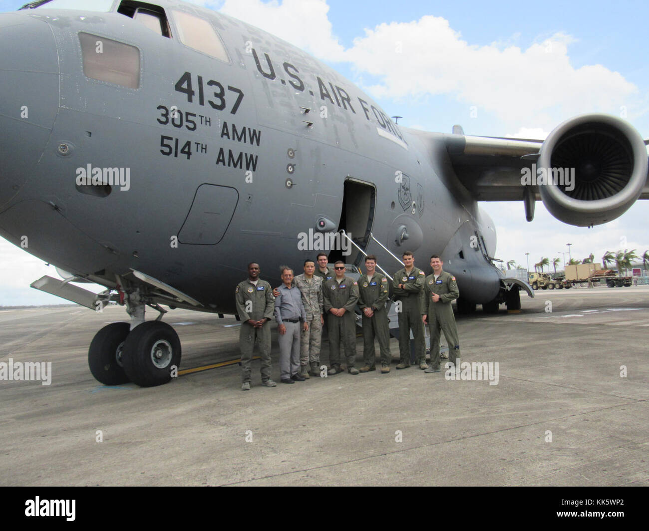 A crew of 6th Airlift Squadron Airman along Staff Sgt. Hector G. Gonzalez, 305th Maintenance Group quality assurance, pose in front of a C-17 Globemaster III at the Luis Muñoz Marín International Airport, Puerto Rico, Oct. 6, 2017. The crew transported FEMA gear, four pallets of supplies, food, water and aid as part of a humanitarian response. Stock Photo
