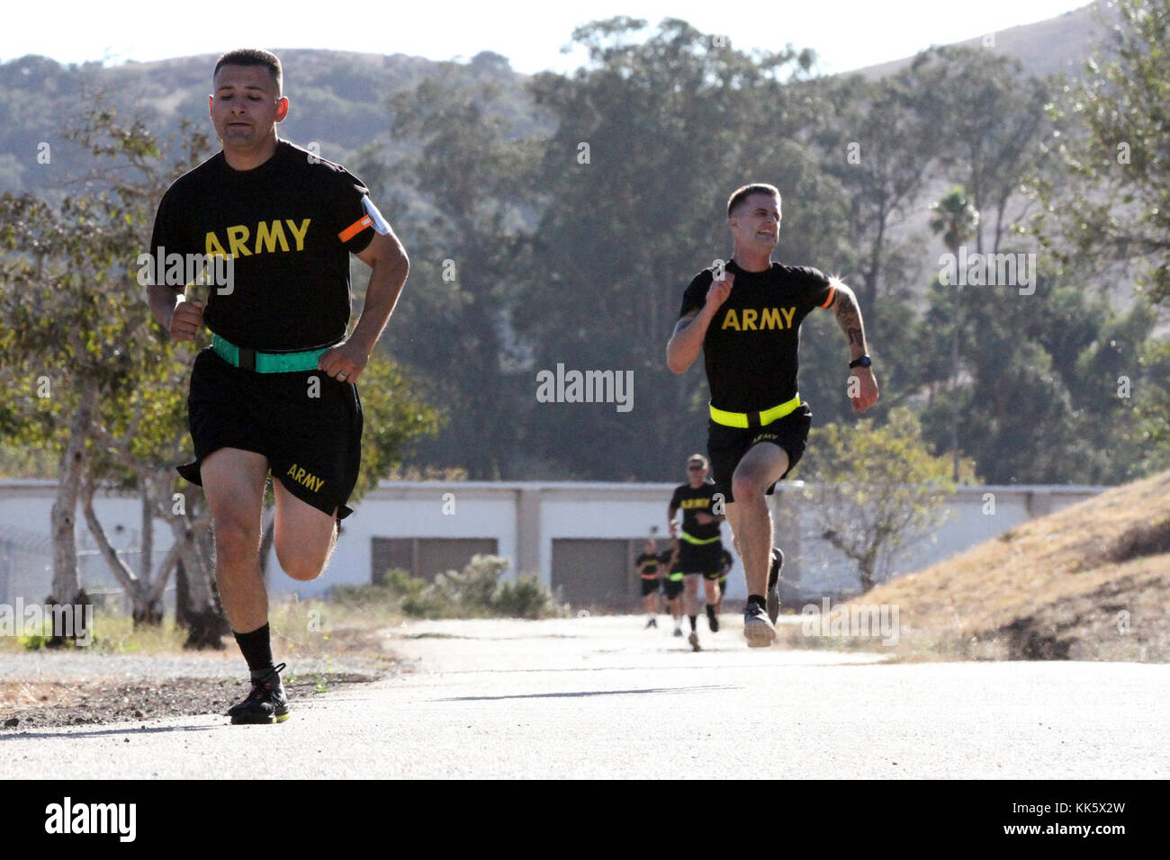 Sgt. George Ruiz, left, of the 49th Personnel Support Company, 115th Regional Support Group, California Army National Guard, battles Spc. Devon Witt to the finish line of the 2-mile run of the Army Physical Fitness Test Nov. 5 during the 2017-18 Best Warrior Competition at Camp San Luis Obispo, California. (Army National Guard photo by Staff Sgt. Eddie Siguenza) Stock Photo