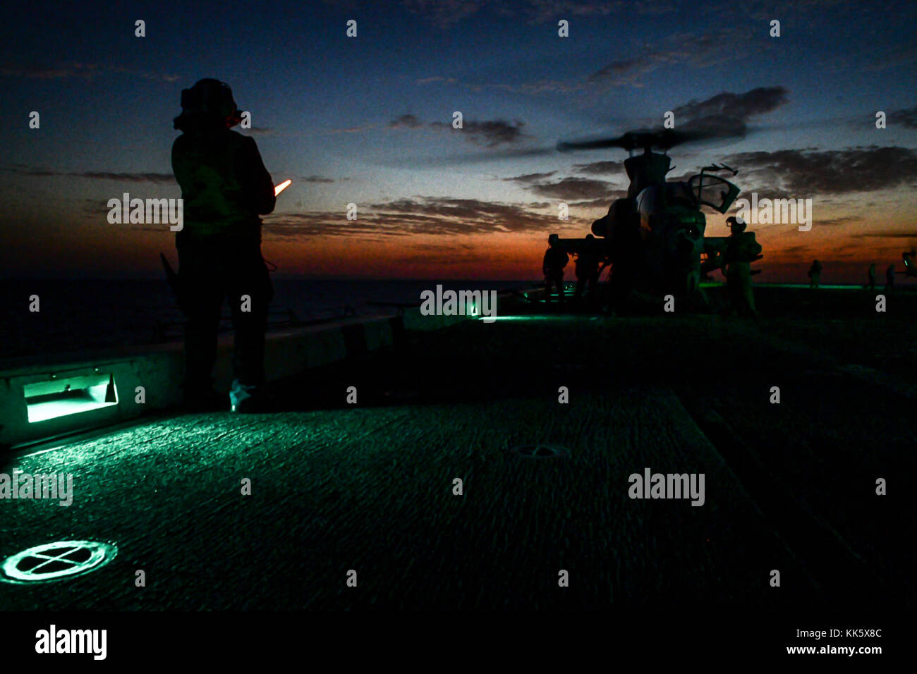 MEDITERRANEAN SEA (Nov. 6, 2017) Aviation Boatswain’s Mate (Handling) 3rd Class Esmerelda Hernandez, from Corpus Christi, Texas, and assigned to the air department aboard the San Antonio-class amphibious transport dock ship USS San Diego (LPD 22), directs an AH-1Z Viper, assigned to Marine Medium Tiltrotor Squadron (VMM) 161 (reinforced), on the ship’s flight deck Nov. 6, 2017 . San Diego is deployed with the America Amphibious Ready Group and the 15th Marine Expeditionary Unit to support maritime security and theater security cooperation in efforts in the U.S. 6th Fleet are Stock Photo