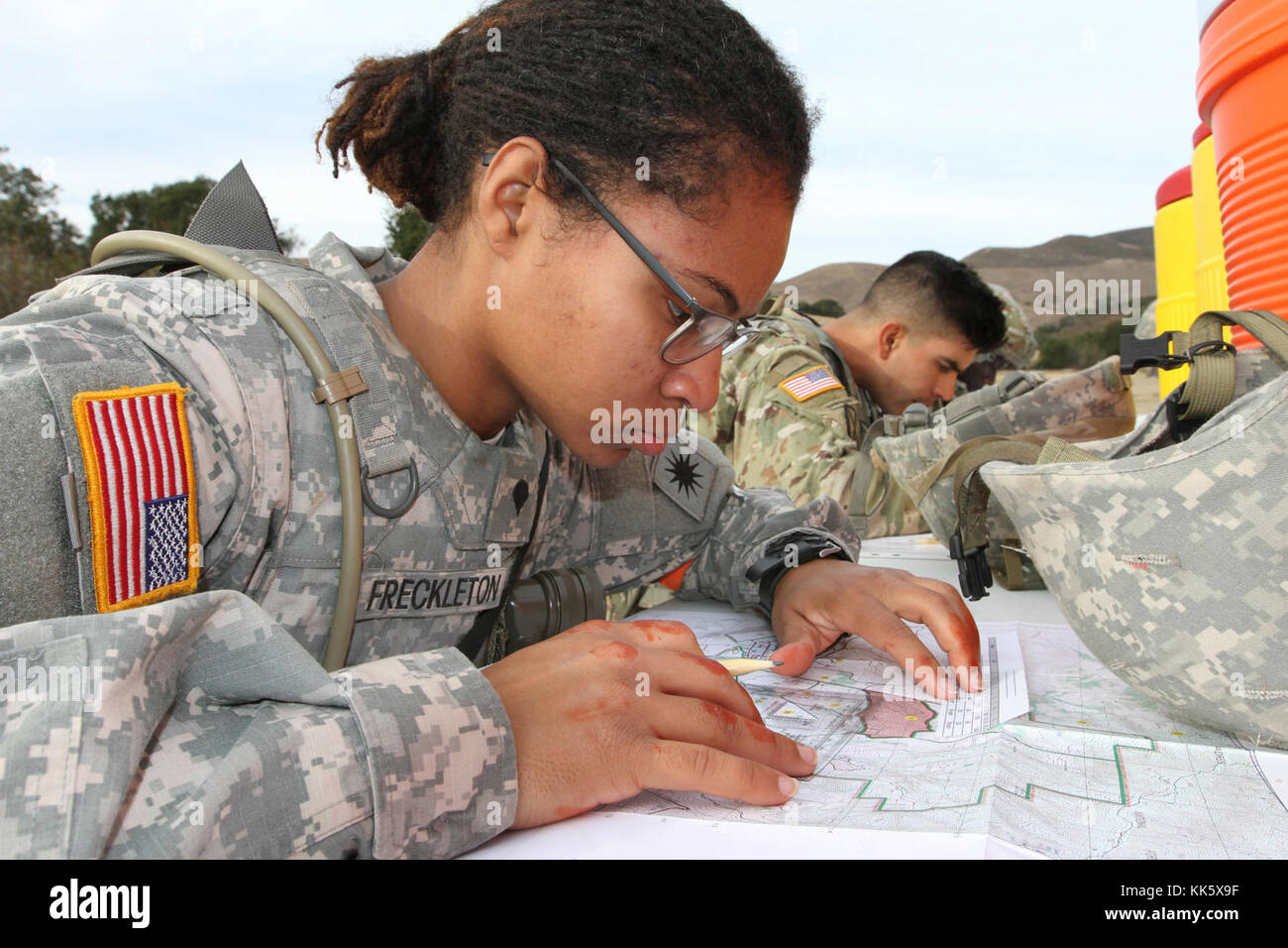 Spc. Emefa Freckleton uses a protractor and map to plot five coordinates Nov. 6 during the day land navigation section of the 2017-18 California Army National Guard Best Warrior Competition Nov. 5 at Camp San Luis Obispo, California. (Army National Guard photo by Staff Sgt. Eddie Siguenza) Stock Photo