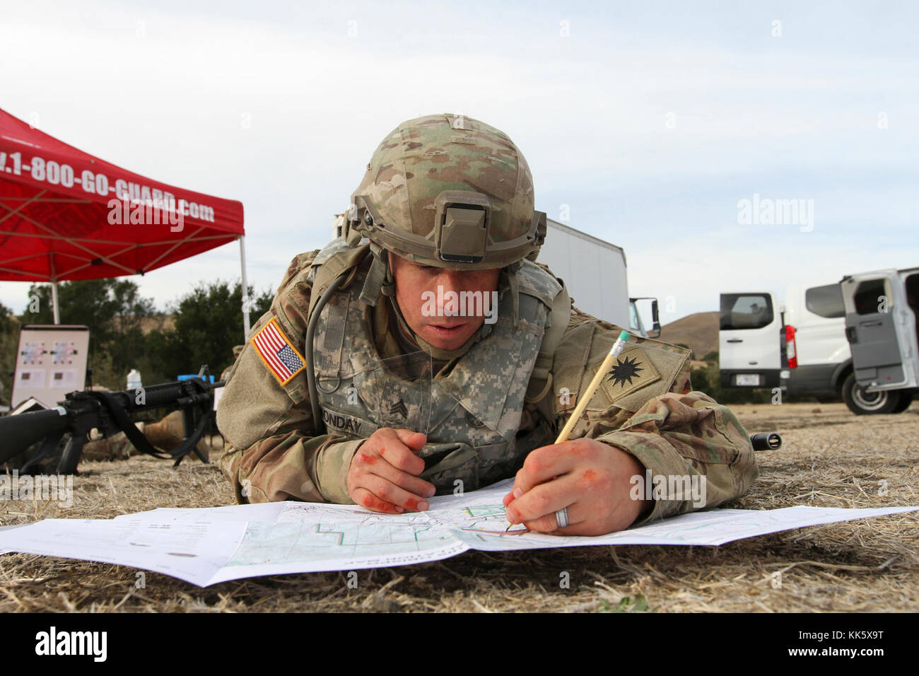 Sgt. Joshua Monday uses a protractor and map to plot five coordinates Nov. 6 during the day land navigation section of the 2017-18 California Army National Guard Best Warrior Competition Nov. 5 at Camp San Luis Obispo, California. (Army National Guard photo by Staff Sgt. Eddie Siguenza) Stock Photo