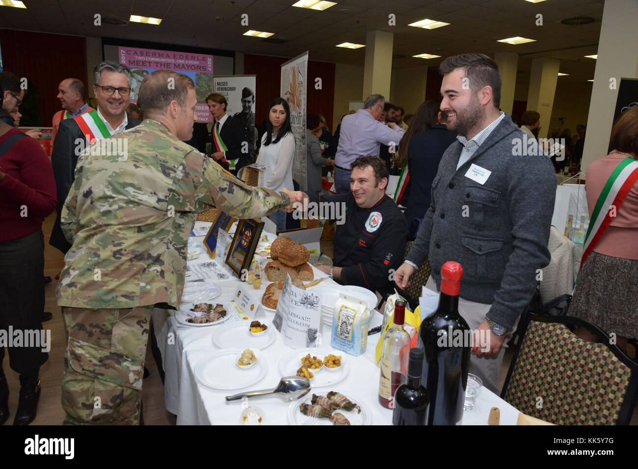 U.S. Col. Eric M. Berdy, U.S. Army Garrison Italy commander, thanks to Emanuele Traverso, cook from Camisano community, during the Meet the Mayors event at the Golden Lion Conference Center on Caserma Ederle, Vicenza, Italy, Nov. 8, 2017.   The event is an informal fair that hosts mayors, council members, and cultural and tourism representatives from Italian townships in the Vicenza and Padova provinces. (U.S. Army Photo by Paolo Bovo) Stock Photo