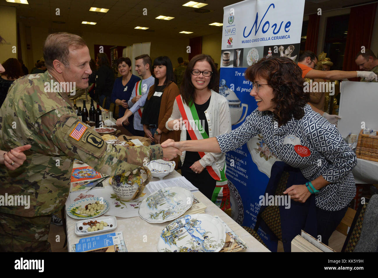 U.S. Col. Eric M. Berdy, U.S. Army Garrison Italy commander, thanks to Elisa Bittante, during the Meet the Mayors event at the Golden Lion Conference Center on Caserma Ederle, Vicenza, Italy, Nov. 8, 2017.   The event is an informal fair that hosts mayors, council members, and cultural and tourism representatives from Italian townships in the Vicenza and Padova provinces. (U.S. Army Photo by Paolo Bovo) Stock Photo