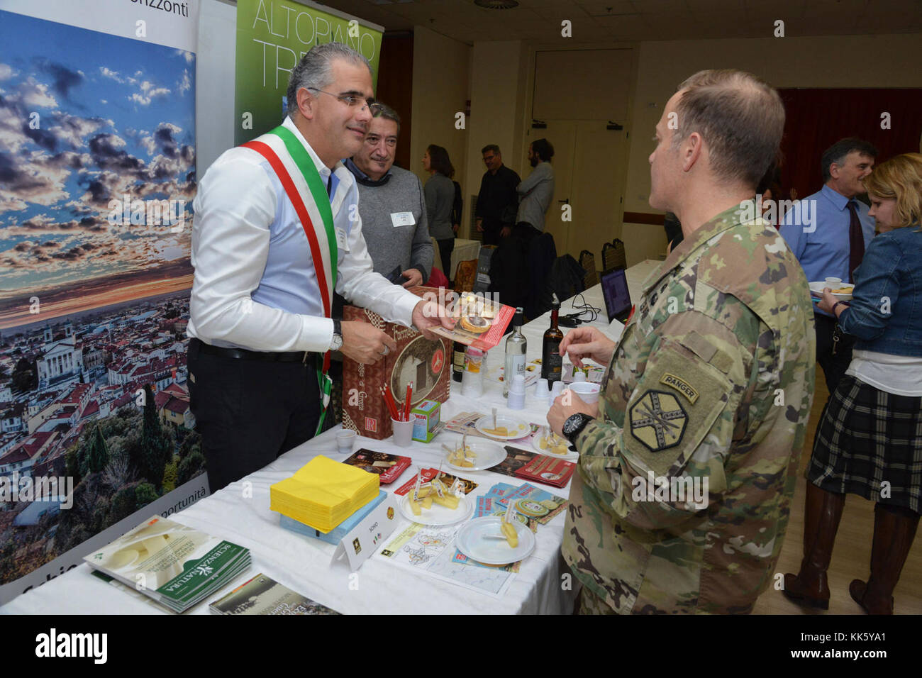 U.S. Col. Eric M. Berdy, U.S. Army Garrison Italy commander, speaks with Roberto Polga, deputy mayor of Schio, during the Meet the Mayors event at the Golden Lion Conference Center on Caserma Ederle, Vicenza, Italy, Nov. 8, 2017.   The event is an informal fair that hosts mayors, council members, and cultural and tourism representatives from Italian townships in the Vicenza and Padova provinces. (U.S. Army Photo by Paolo Bovo) Stock Photo
