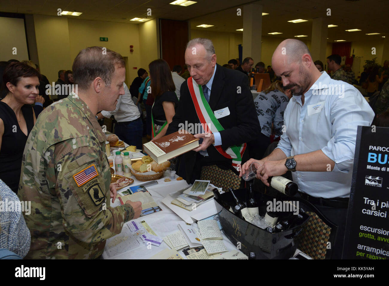 U.S. Col. Eric M. Berdy, U.S. Army Garrison Italy commander, receives a book from Giovanni Fattori, councilman of Sovizzo, during the Meet the Mayors event at the Golden Lion Conference Center on Caserma Ederle, Vicenza, Italy, Nov. 8, 2017.   The event is an informal fair that hosts mayors, council members, and cultural and tourism representatives from Italian townships in the Vicenza and Padova provinces. (U.S. Army Photo by Paolo Bovo) Stock Photo