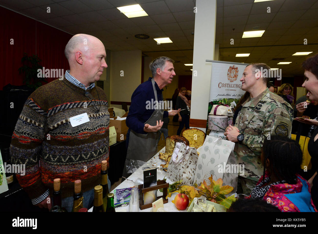 U.S. Col. Eric M. Berdy, U.S. Army Garrison Italy commander, speaks with David Ozbun during the Meet the Mayors event at the Golden Lion Conference Center on Caserma Ederle, Vicenza, Italy, Nov. 8, 2017.   The event is an informal fair that hosts mayors, council members, and cultural and tourism representatives from Italian townships in the Vicenza and Padova provinces. (U.S. Army Photo by Paolo Bovo) Stock Photo