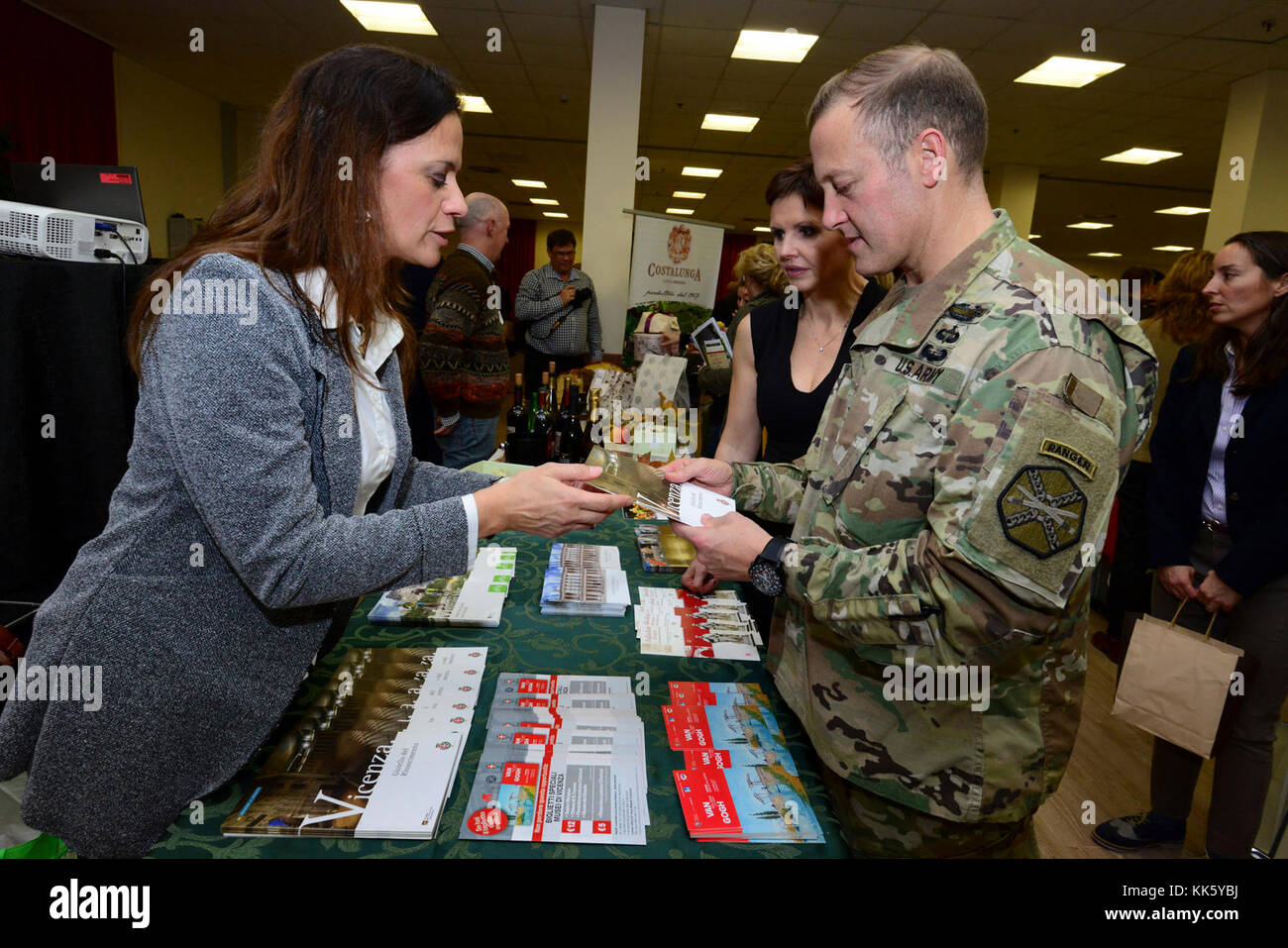 U.S. Col. Eric M. Berdy, U.S. Army Garrison Italy commander, speaks with Romina Muraro, tourism office, during the Meet the Mayors event at the Golden Lion Conference Center on Caserma Ederle, Vicenza, Italy, Nov. 8, 2017.   The event is an informal fair that hosts mayors, council members, and cultural and tourism representatives from Italian townships in the Vicenza and Padova provinces. (U.S. Army Photo by Paolo Bovo) Stock Photo