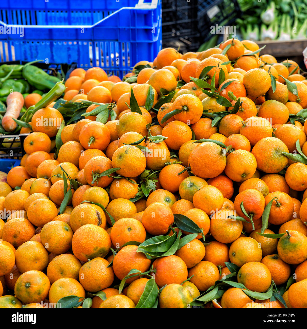 a lot of oranges stacked in a market outside ready for sale Stock Photo