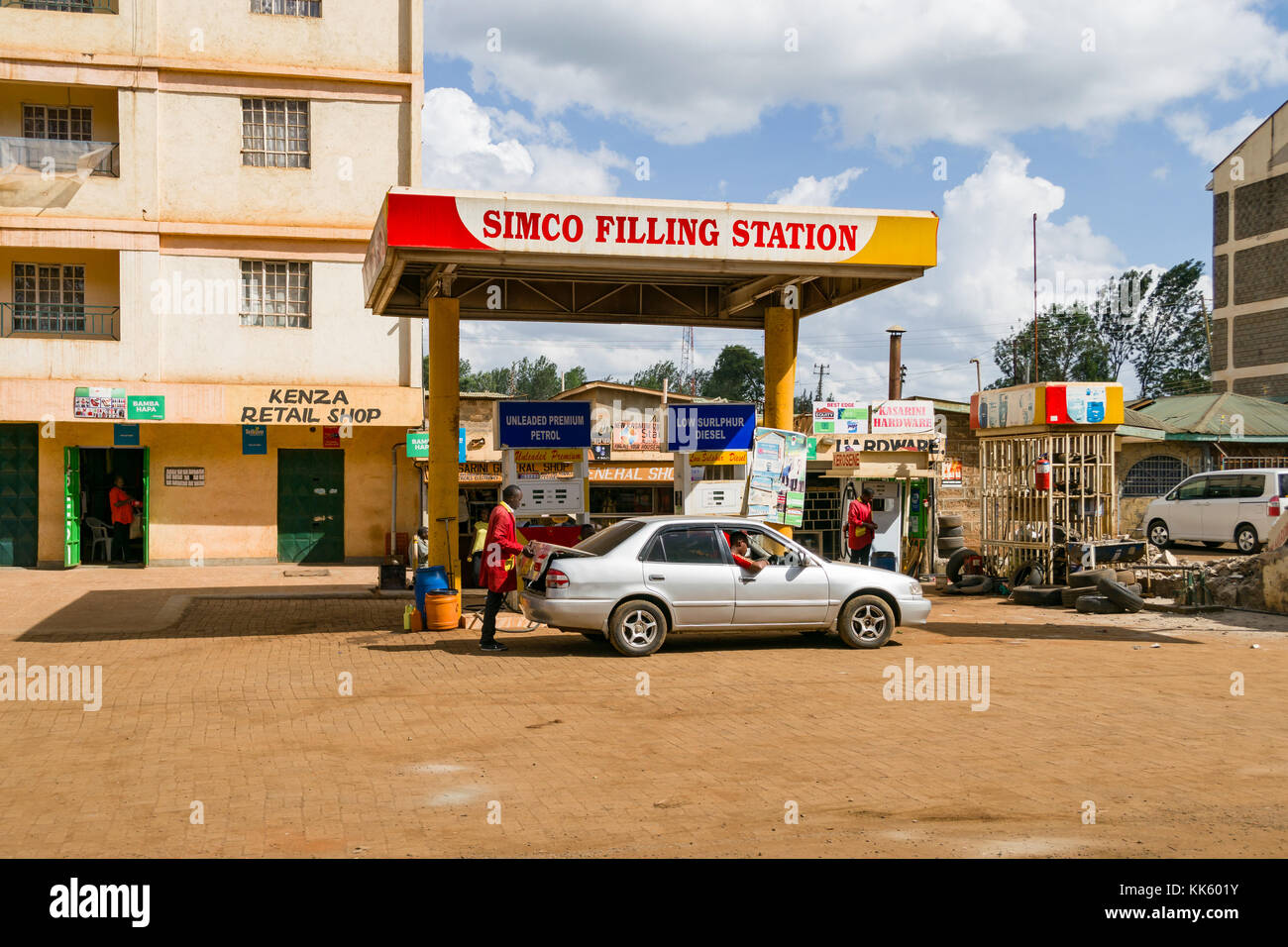 A SIMCO petrol filling station with attendants and customers in vehicle refuelling, Kenya, East Africa Stock Photo