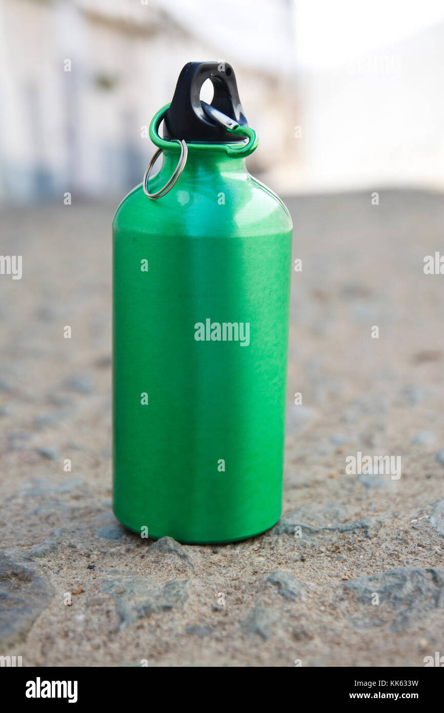 Green bottle of water in ground at rural outdoors Stock Photo - Alamy