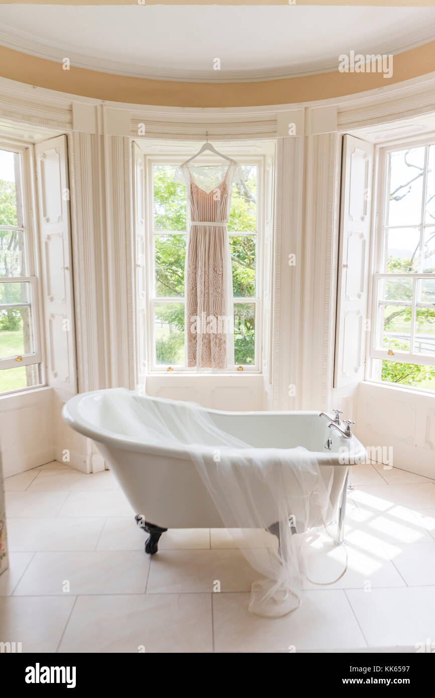 wedding dress in bathroom Stock Photo - Alamy