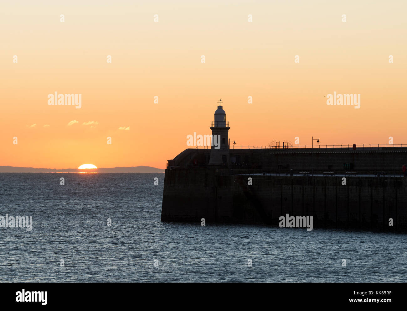 Lighthouse on the Folkestone Harbour Arm at sunrise, Kent Stock Photo