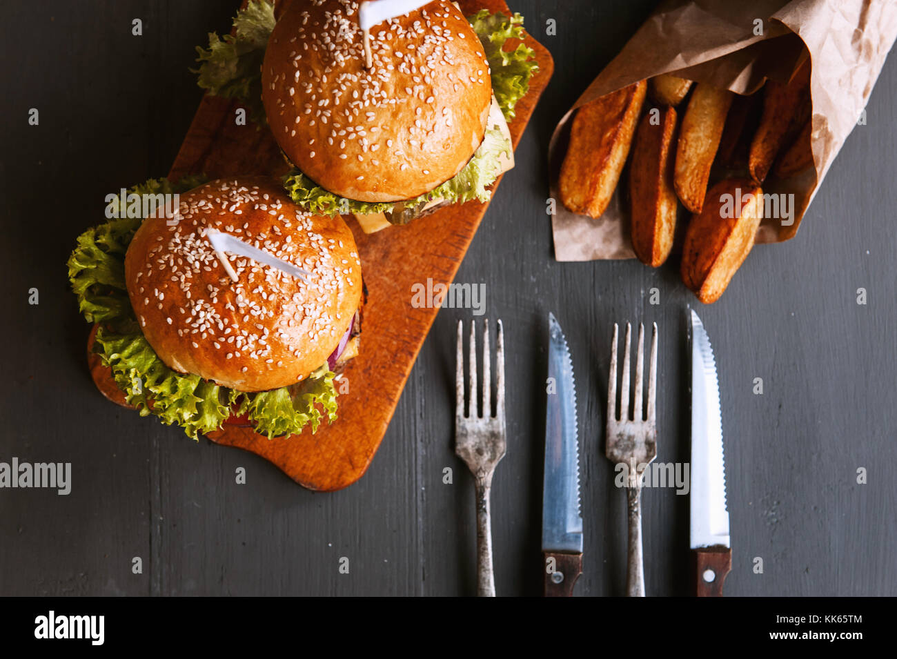 Two mouthwatering, delicious homemade burger used to chop beef. on the wooden table Stock Photo
