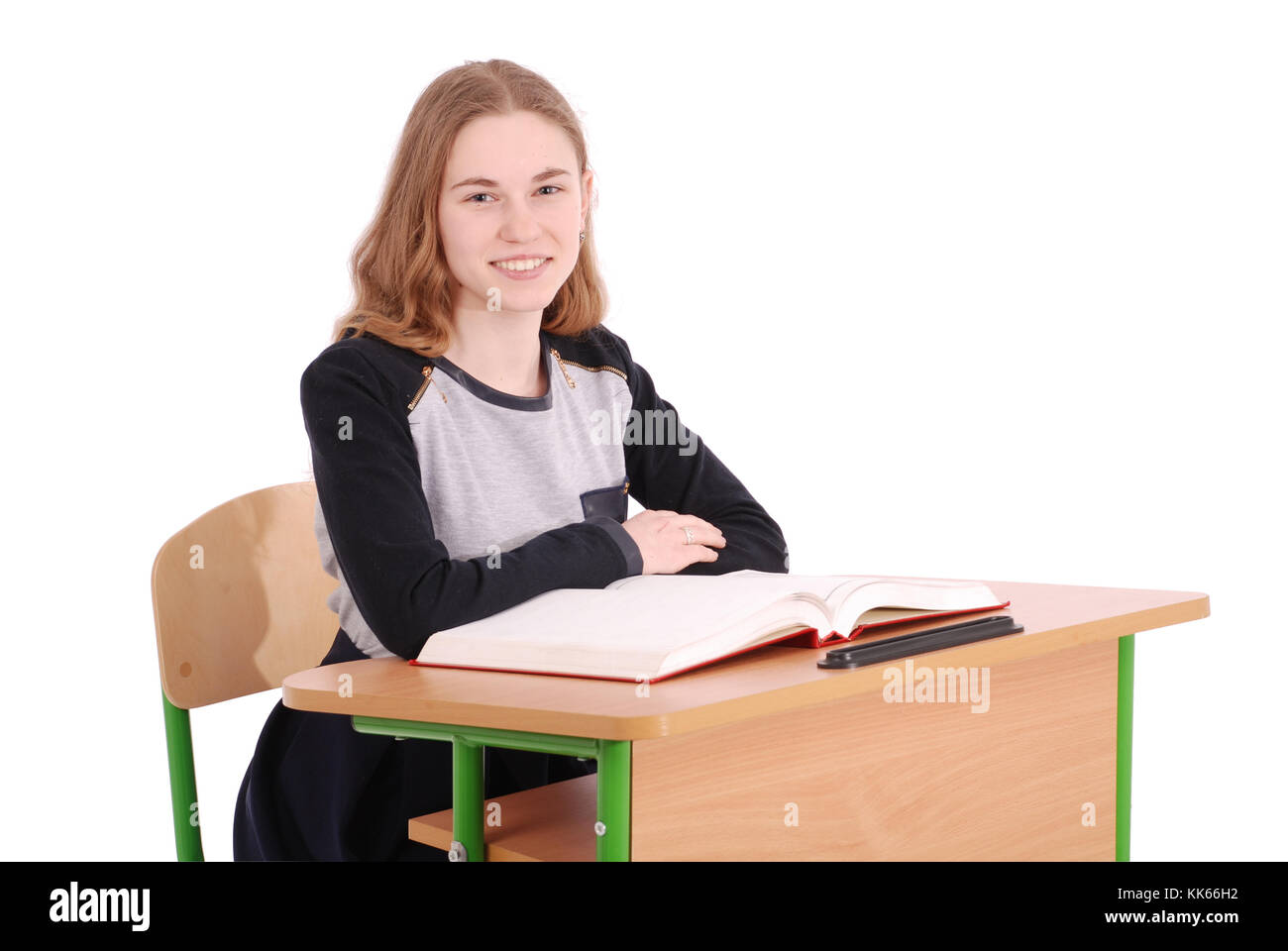 School girl sitting at a desk isolated on white Stock Photo - Alamy