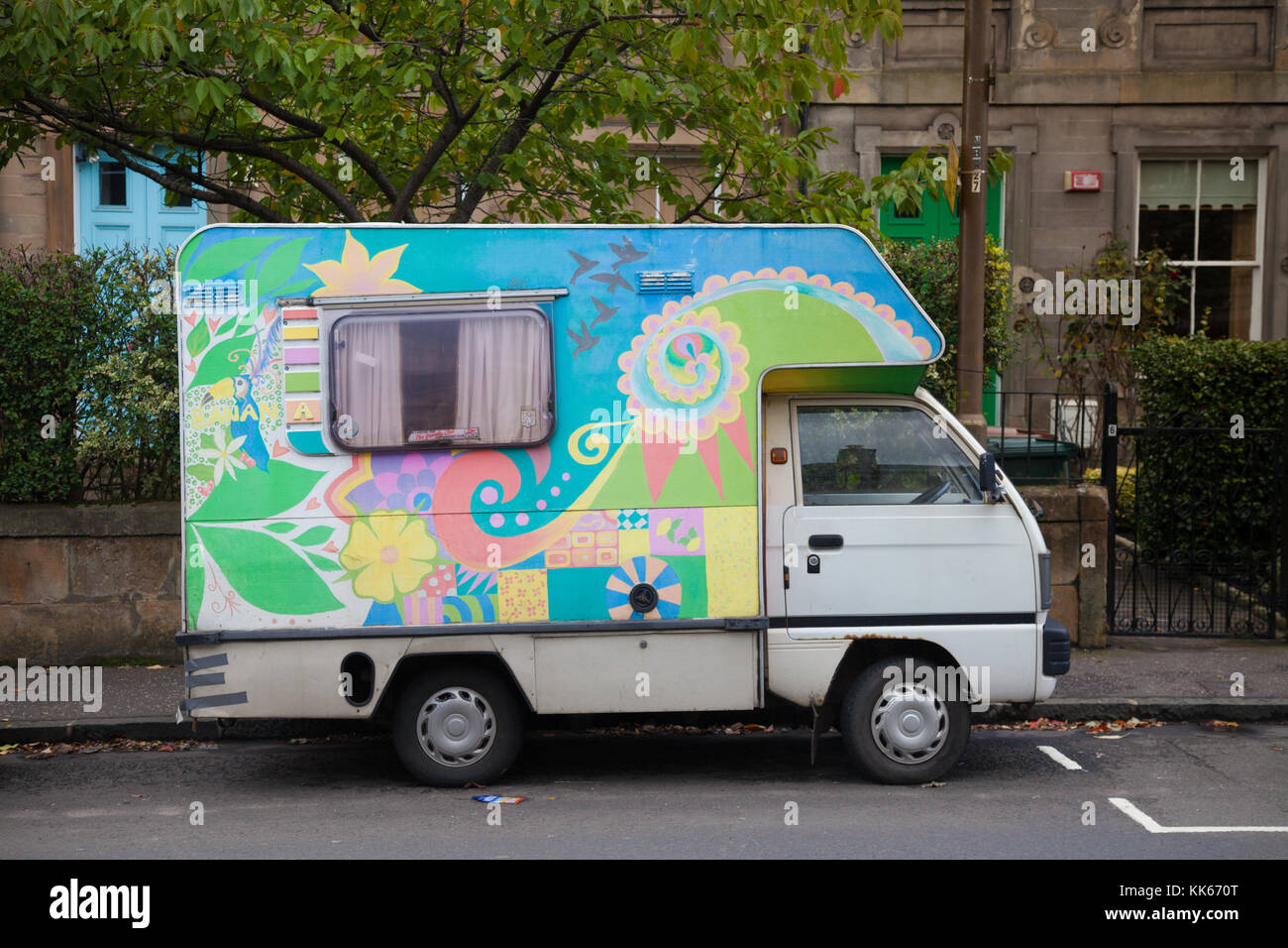 An old motor home with bright paint work parked in a street in Edinburgh. Stock Photo