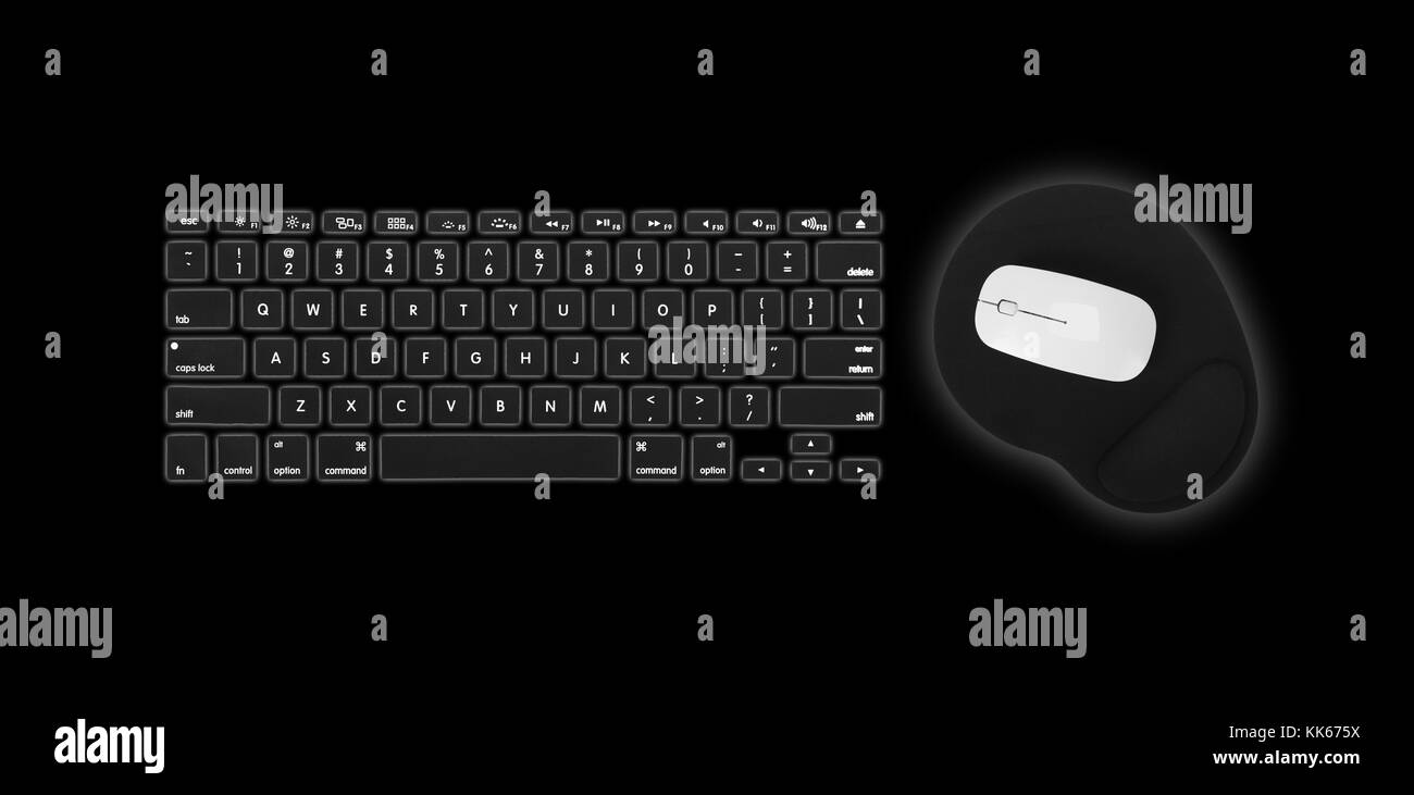 Computer keyboard, mouse and mousepad on a black background Stock Photo