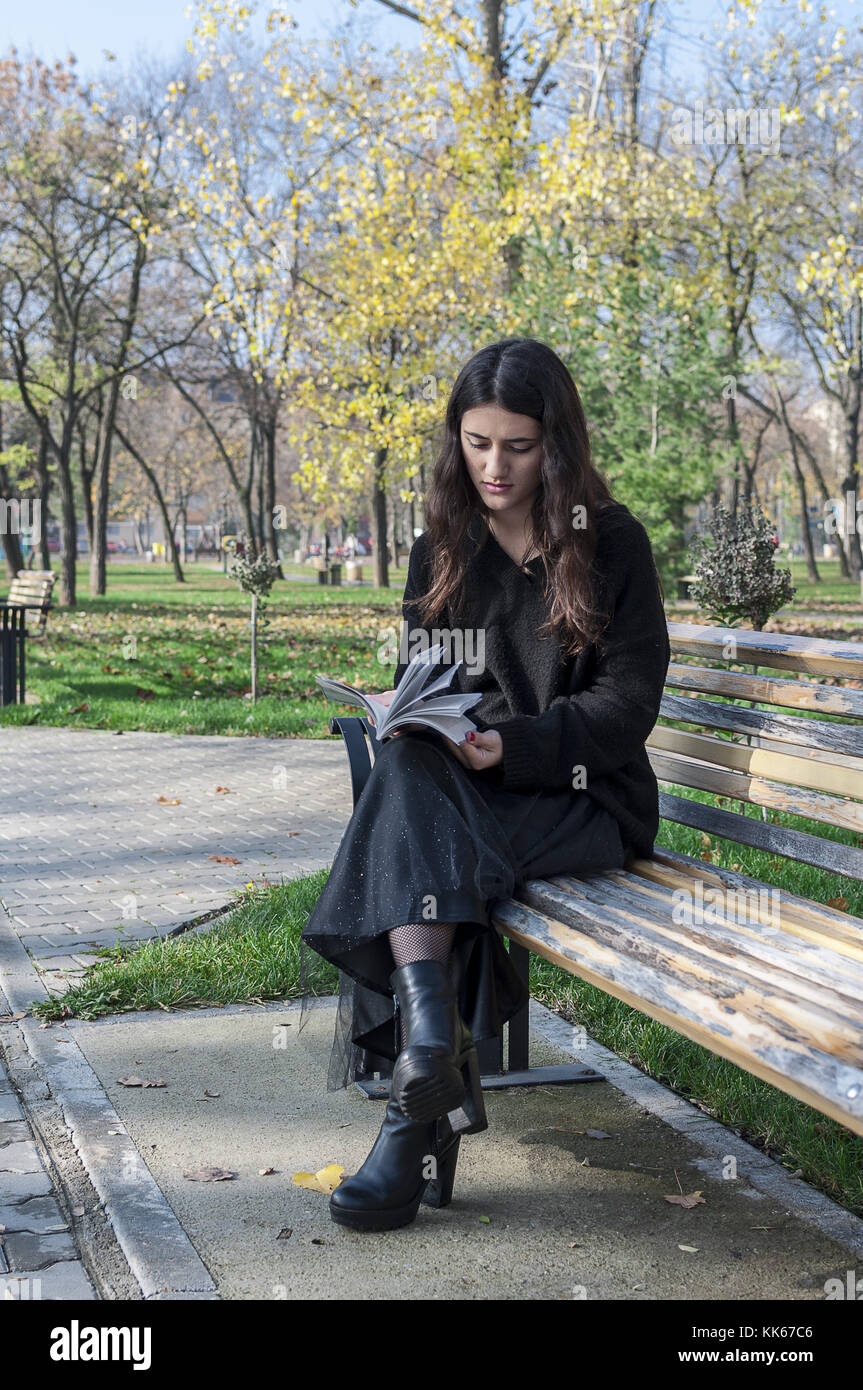 Girl sitting on bench hi-res stock photography and images - Alamy