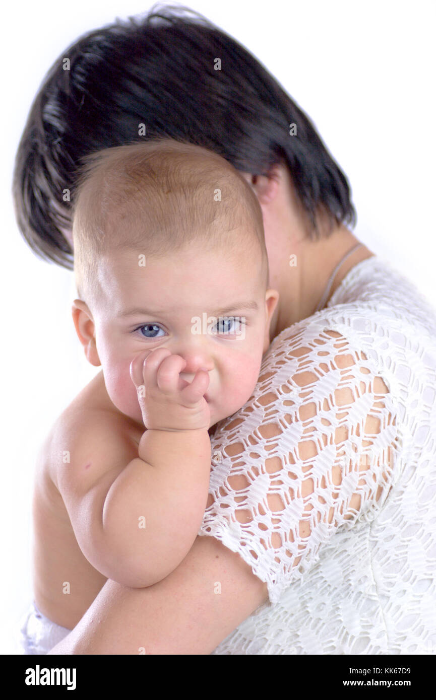 Baby chewing finger holded by mother isolated on white Stock Photo Alamy