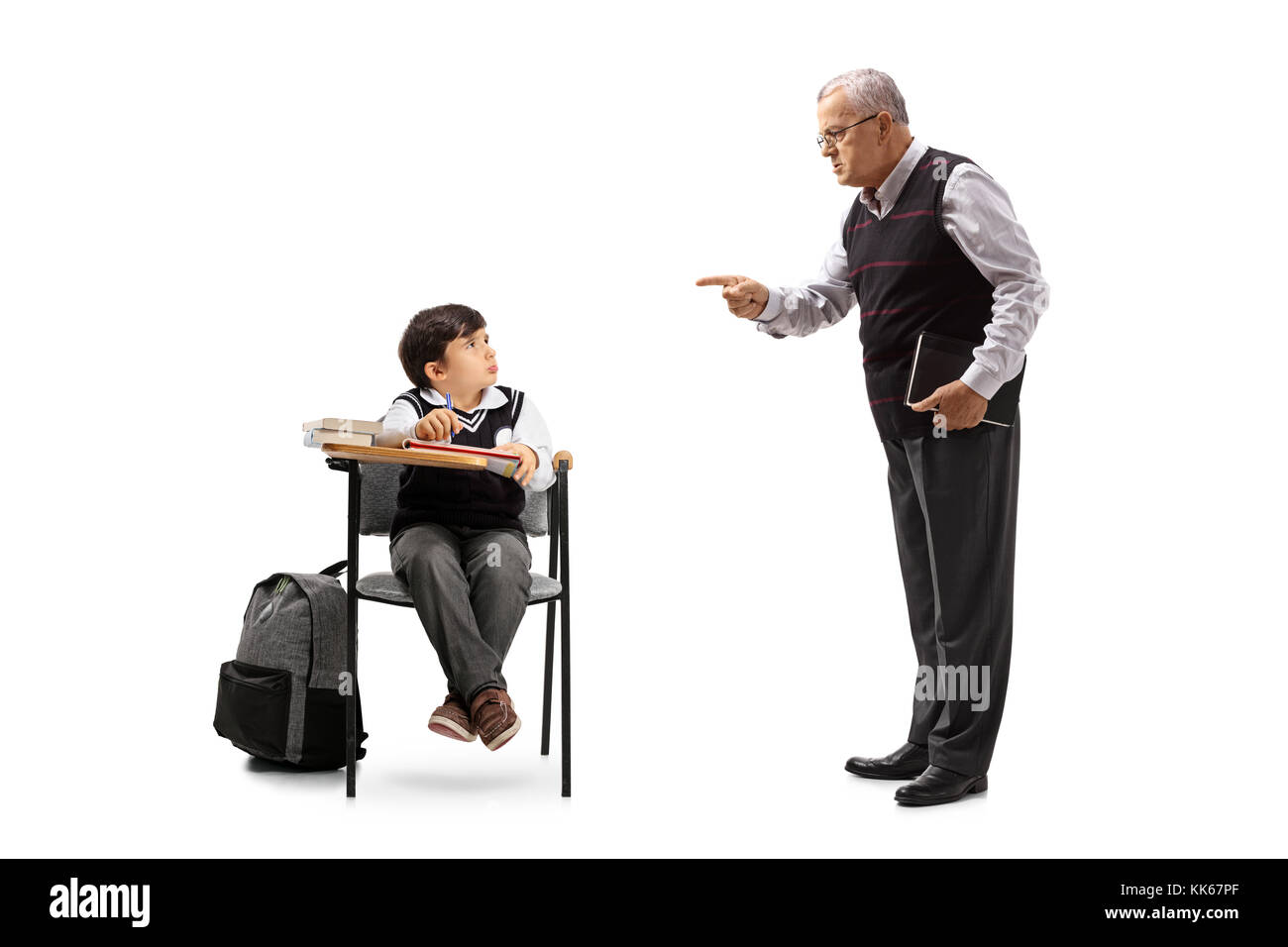 Teacher scolding a little schoolboy seated in a school chair isolated
