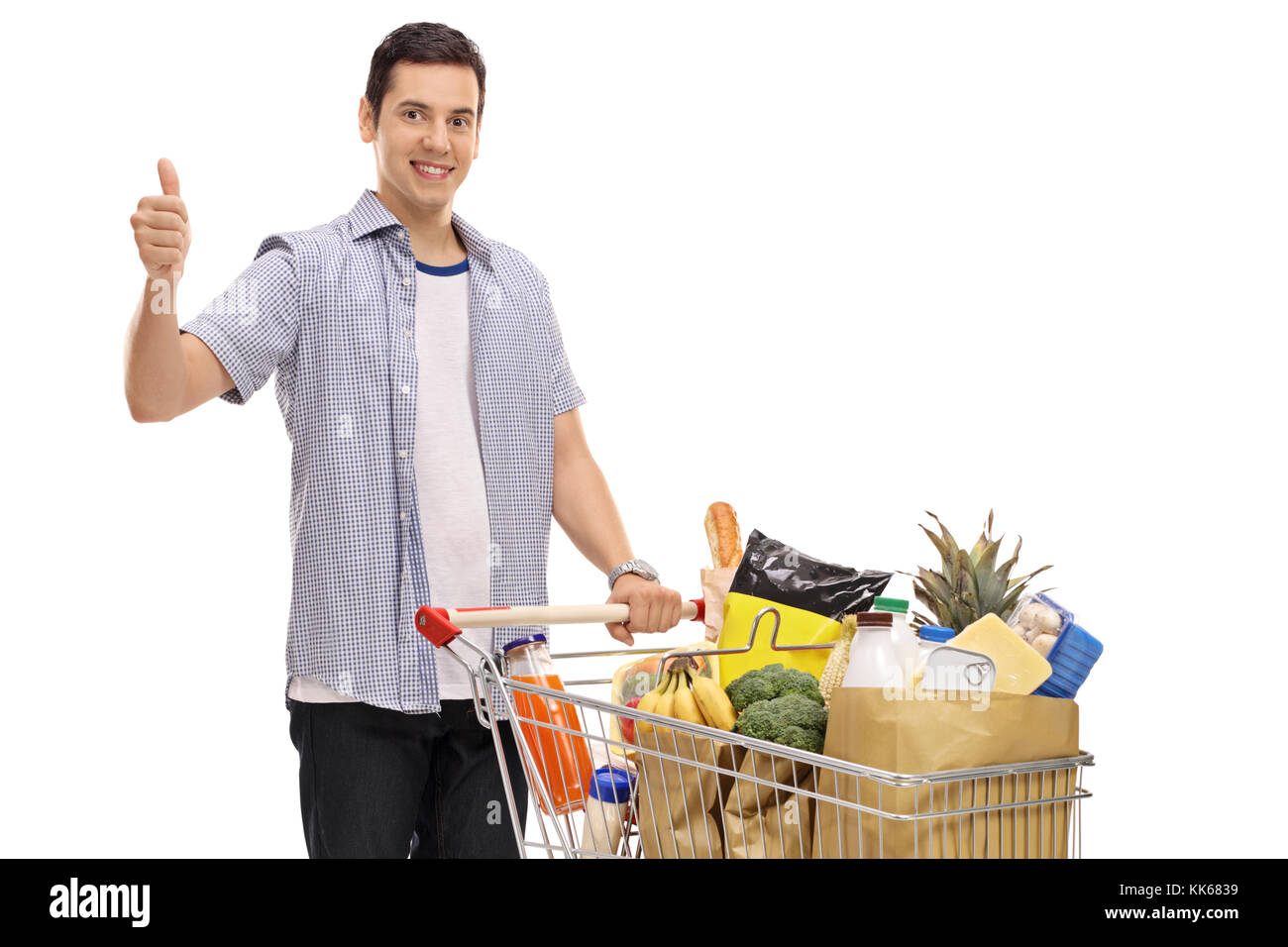 Guy with a shopping cart filled with groceries making a thumb up