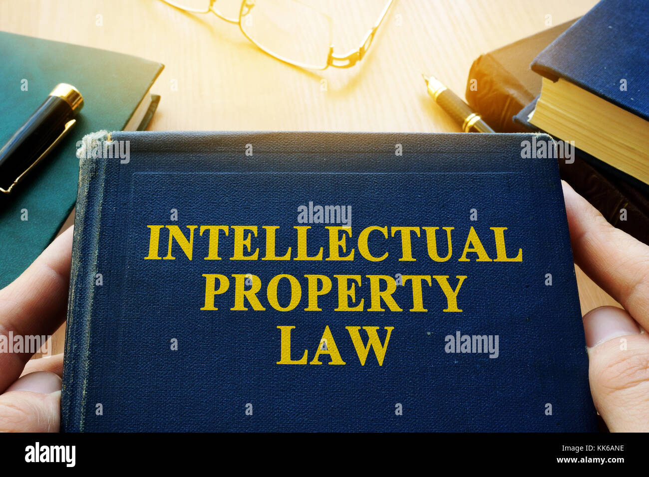 Copyright infringement concept. Intellectual property law and other books on a desk. Stock Photo