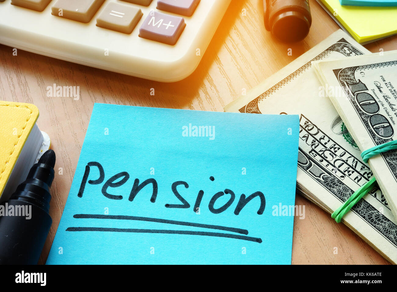 Savings for retirement. Stick with word pension and money on a table. Stock Photo