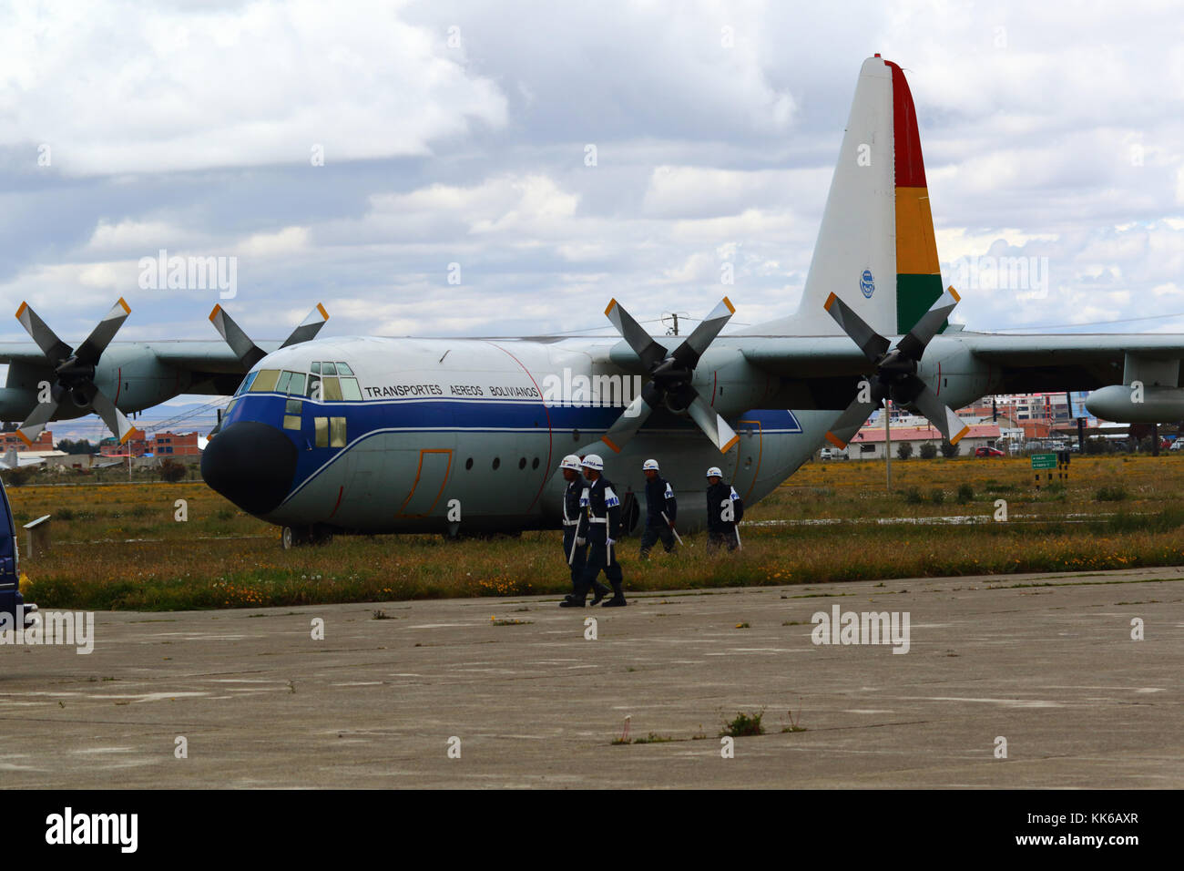 Air Force police walking past Transportes Aereos Bolivianos / TAB Bolivia Lockheed C-130 Hercules plane, El Alto airport, Bolivia Stock Photo