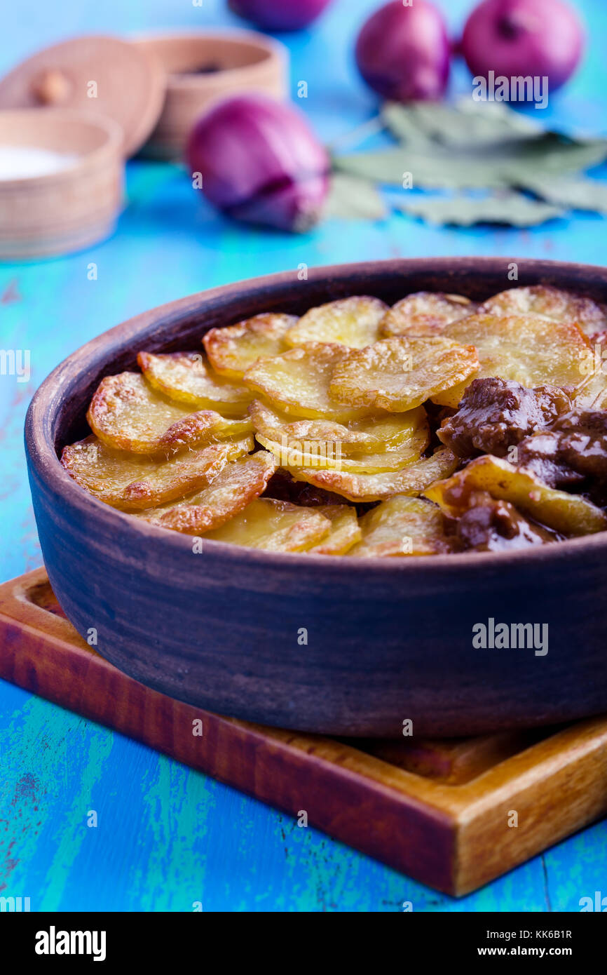 Homemade  meat stew topped with sliced potatoes in ceramic bowl, traditional British pub dish Stock Photo