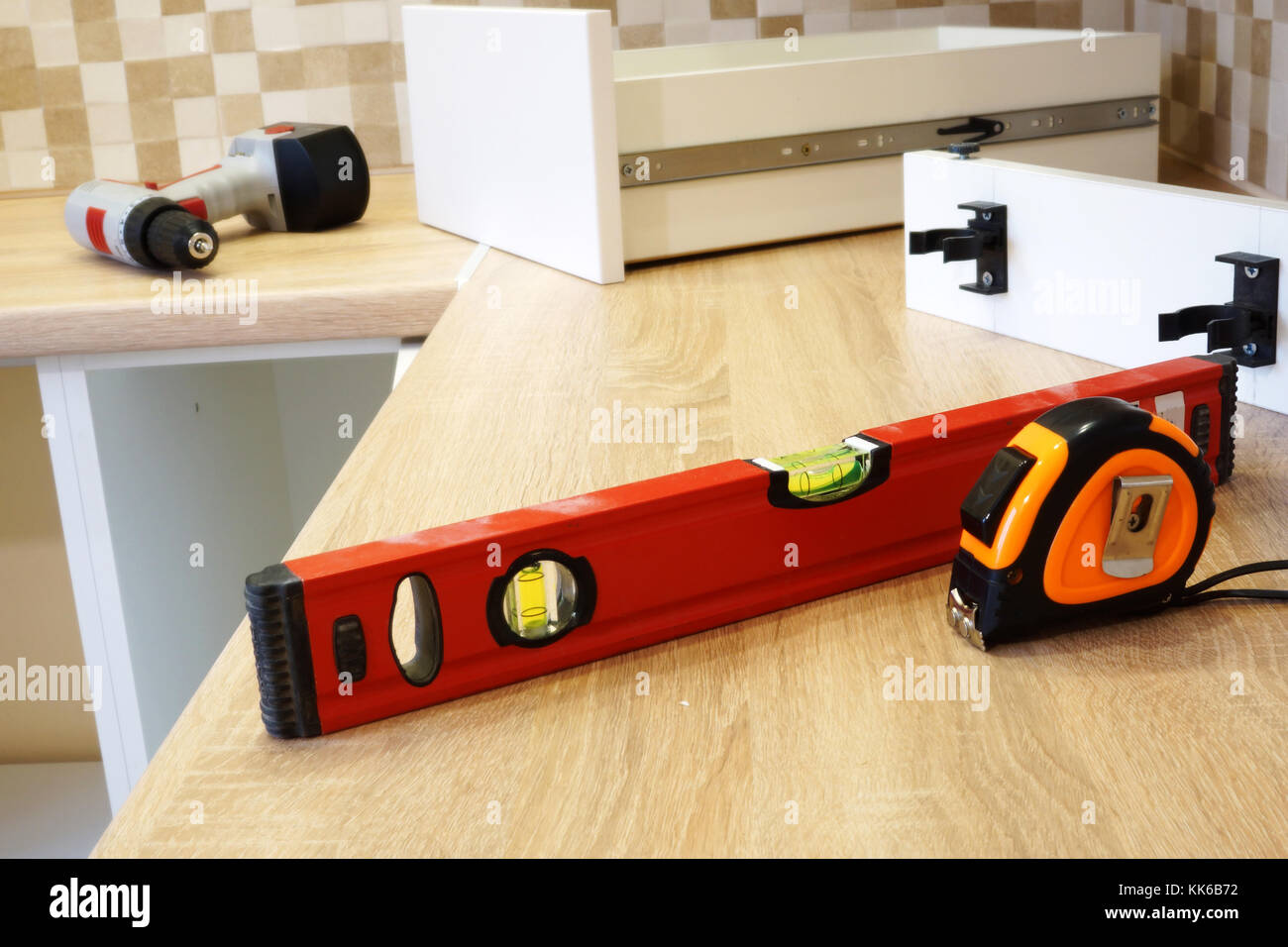 Installation of furniture in the kitchen. Assembly of cabinets. Stock Photo