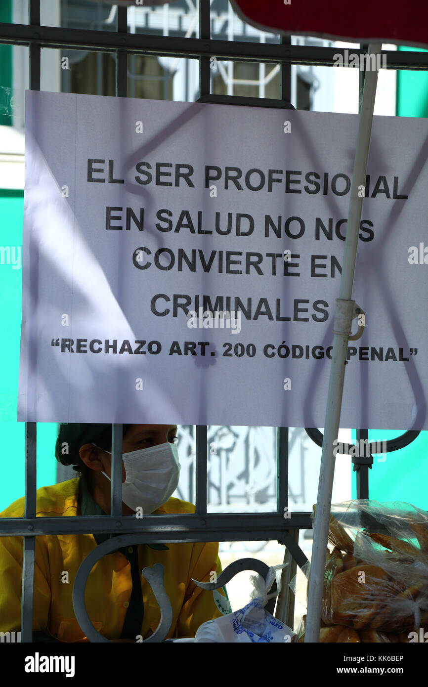 Striking health service worker and sign protesting against changes to laws that would make medical negligence a criminal offence, La Paz, Bolivia Stock Photo
