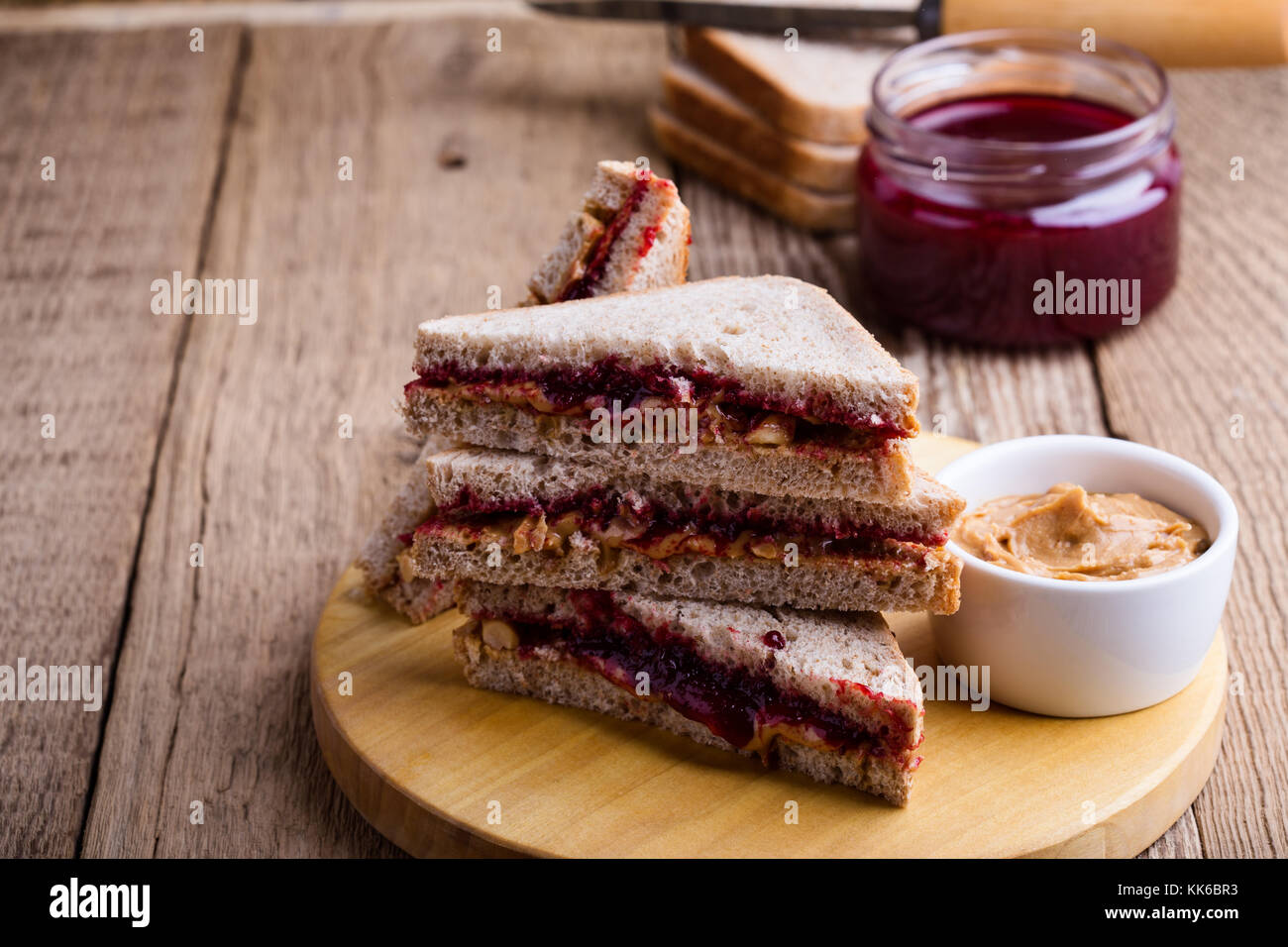 Peanut butter and jelly sandwich with whole wheat bread on rustic