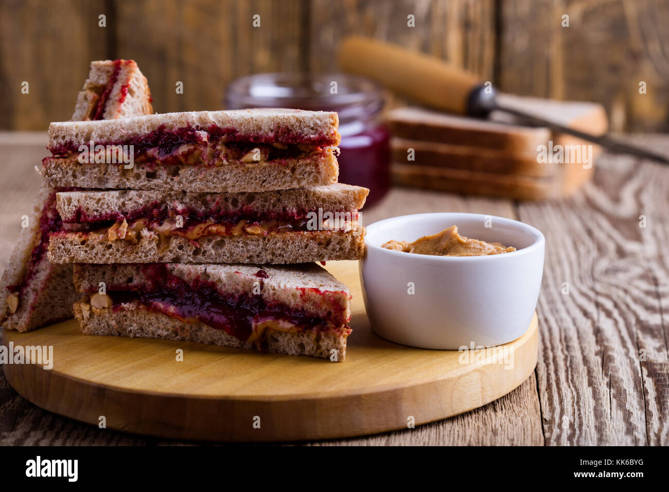 Peanut butter and jelly sandwich with whole wheat bread on rustic
