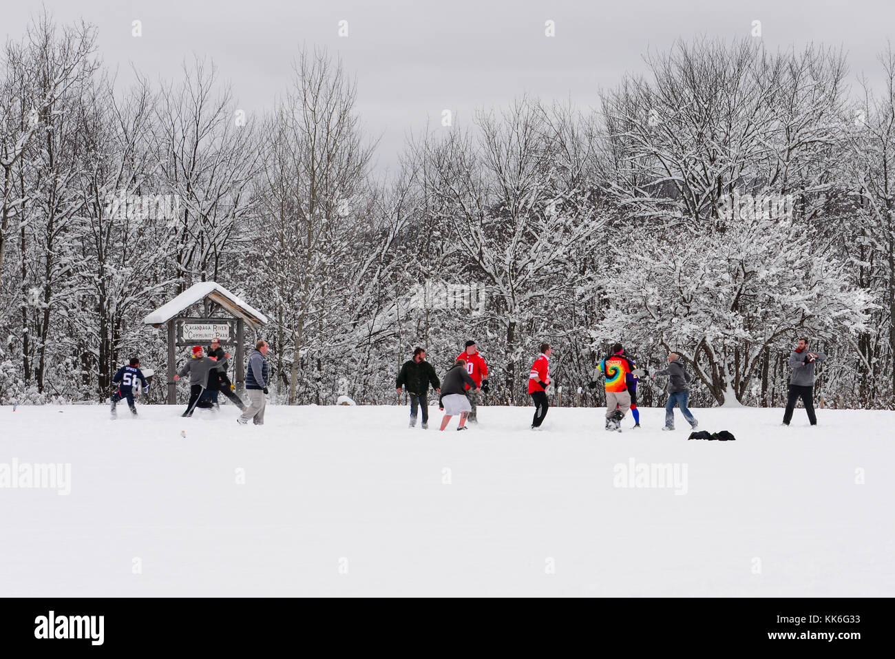 Friendly game of American football in the snow on a Thanksgiving holiday. Stock Photo