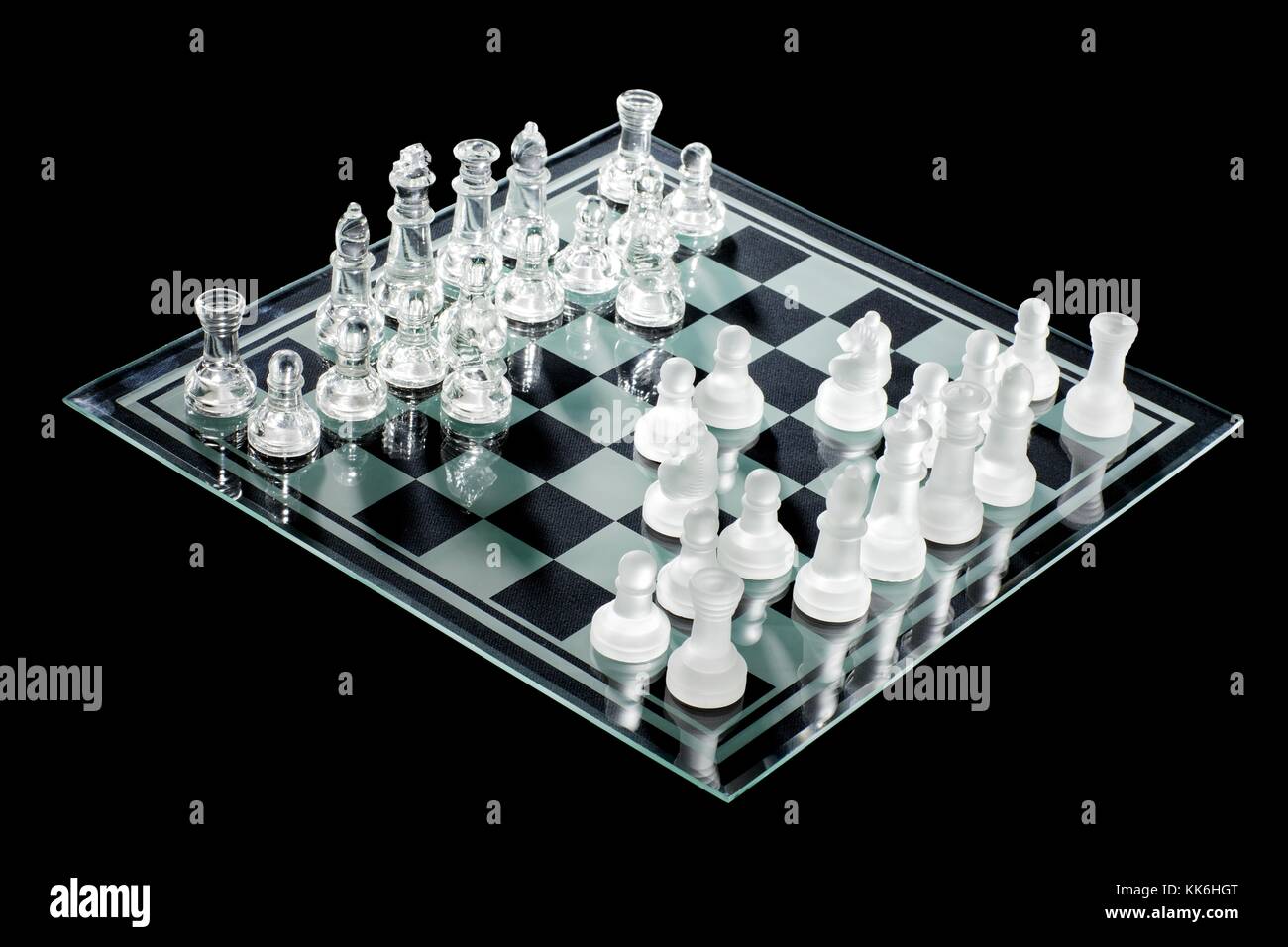 set of glass chess pieces on chess board Stock Photo - Alamy