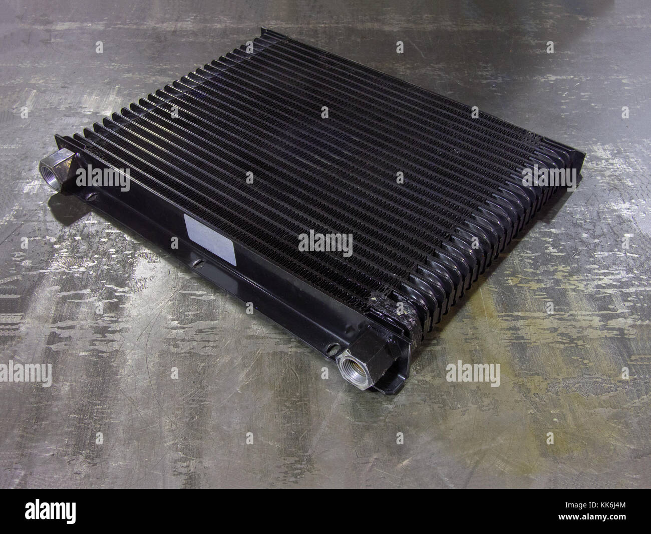 convective cooling radiator. Spare part for industrial equipment or vehicle on an  iron surface Stock Photo