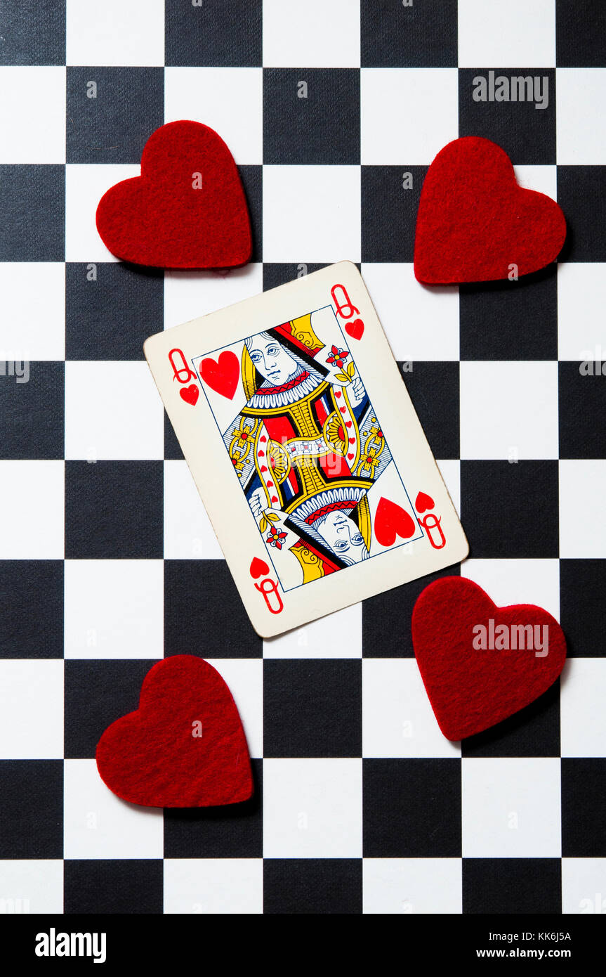 Queen of heart playing card with heart shaped felt on a checkerboard Stock Photo