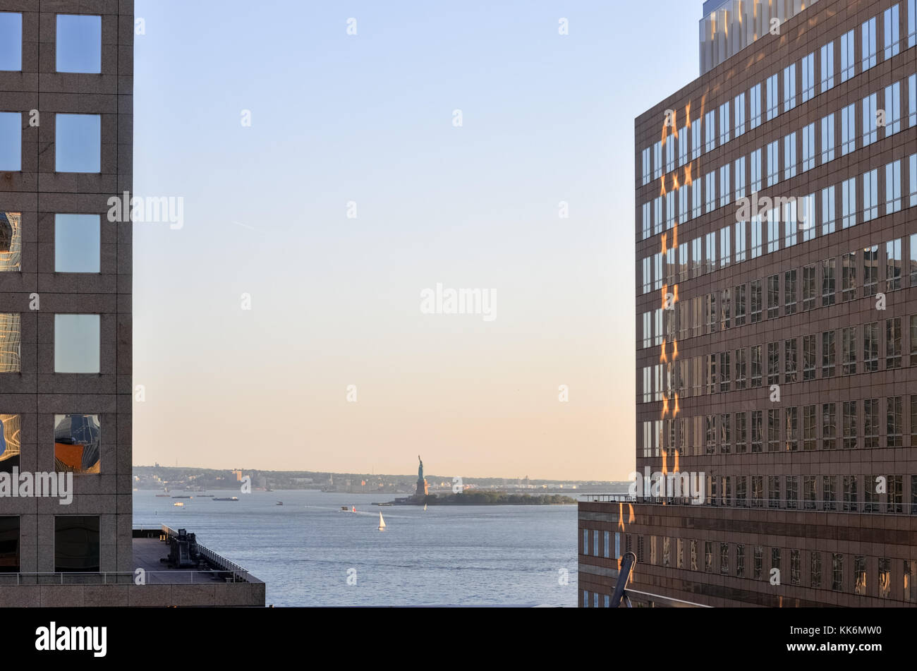 View of the Statue of Liberty from the World Financial Center in Lower Manhattan at dusk. Stock Photo