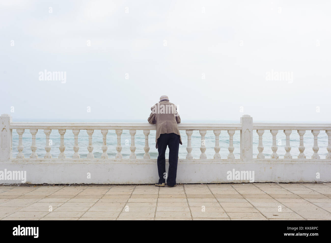 Old man thinking while looking to the ocean Stock Photo