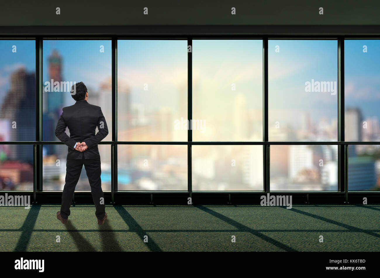 Back side of Businessman looking megalopolis through window, Business concept Stock Photo