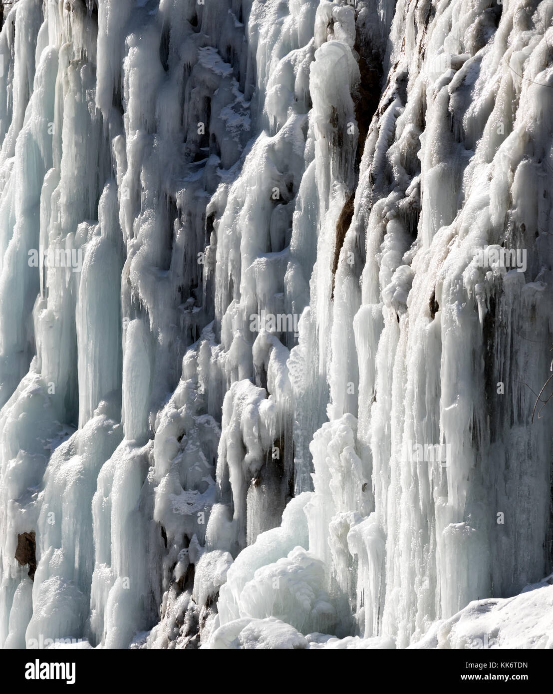 Icy mountain waterfall at cold sun day. Winter in Stock Photo