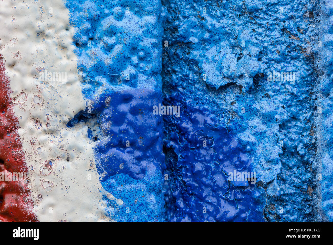 Macro close-up of colorful spray paints on an unevel wall. Stock Photo