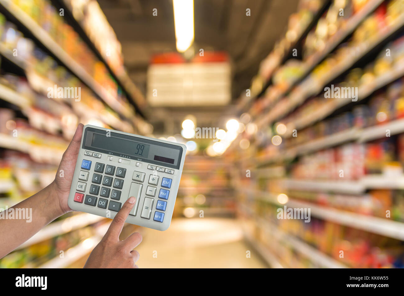 Hand touching buttons of calculator on the Abstract blurred photo of store  in department store bokeh background, business shopping concept Stock Photo  - Alamy