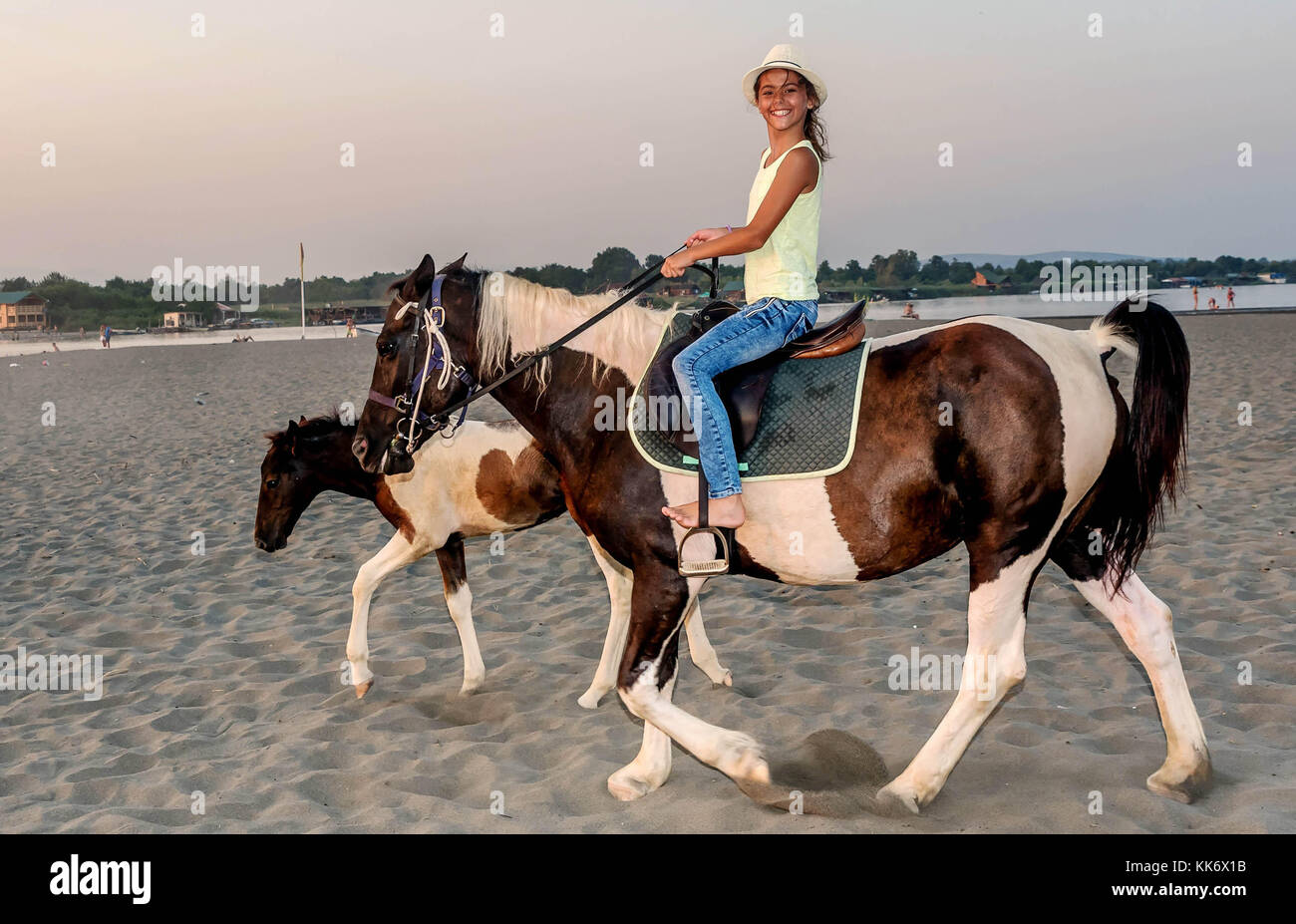 Girl with a hat riding a horse Stock Photo Alamy