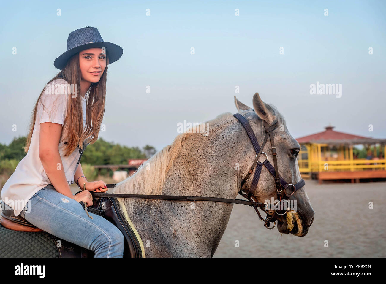 Girl with a hat riding a horse Stock Photo Alamy