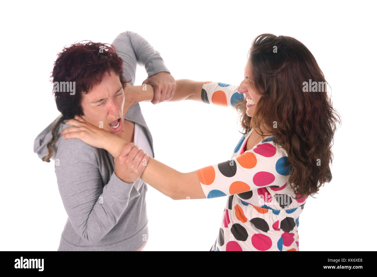 Two young woman fighting over a white background Stock Photo Alamy