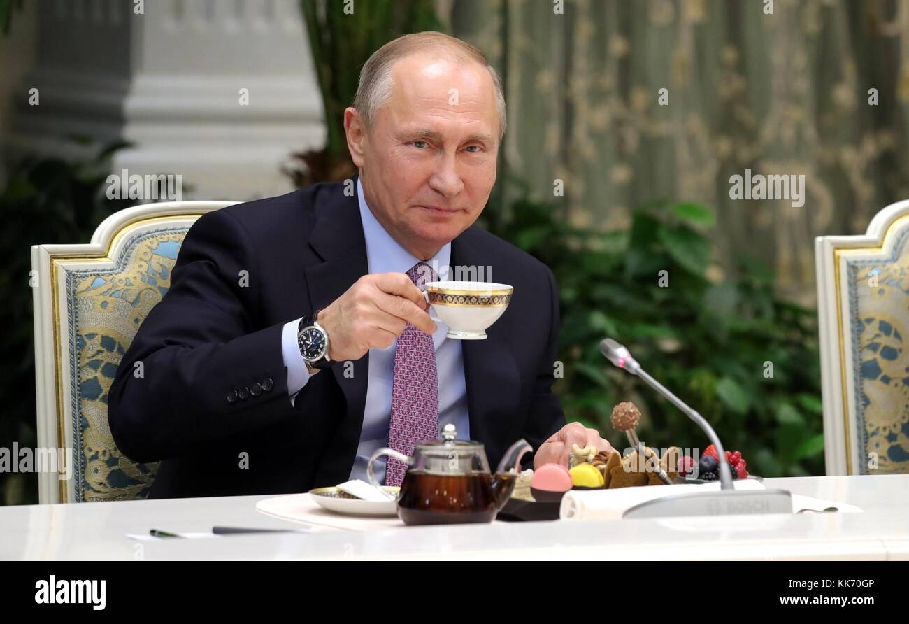 Russian President Vladimir Putin drinks a cup of tea during a meeting with the winners of the Family of the Year national contest November 28, 2017 in Moscow, Russia. Stock Photo