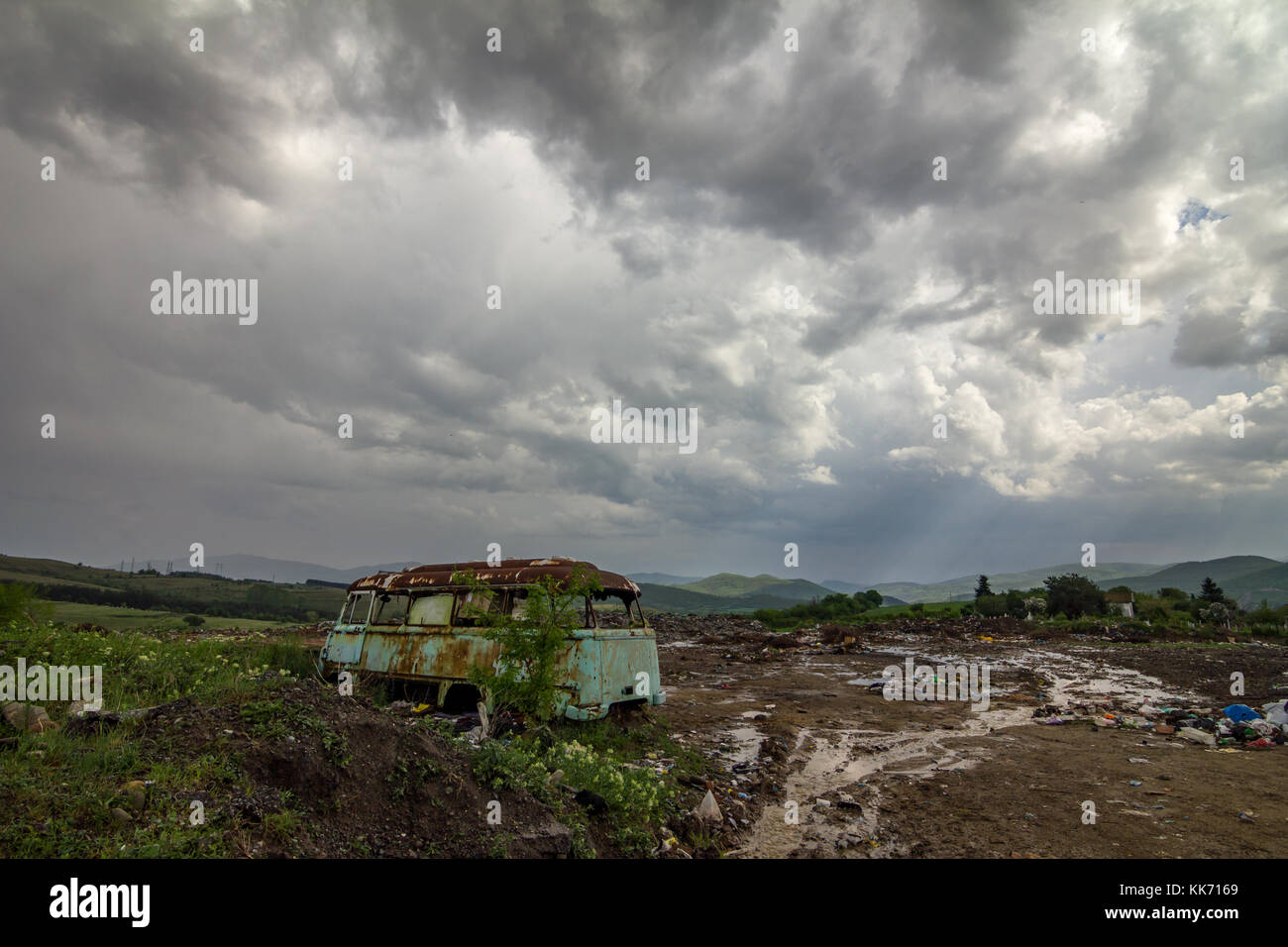 Old abandoned bus wreck. Colorful landscape photo with heavy clouds and contrast sky Stock Photo